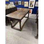 18th cent. Oak refectory table the three plank top above turned legs with a tied stretcher.