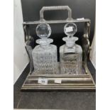 19th cent. Silver plate Betjemans Patent two bottle Tantalus with mismatched decanters and