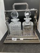 19th cent. Silver plate Betjemans Patent two bottle Tantalus with mismatched decanters and