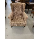 19th cent. Wingback armchair on turned castored supports, re-upholstered.