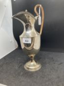 Hallmarked silver claret jug with hinged cover on circular foot with gadroon pattern border,