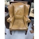 Early 20th cent. Mahogany wing chair shaped back with out-scrolled arms raised over squared fluted