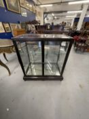 20th cent. Chinoiserie style ebonised display cabinet, four glazed sides above a fretwork base.