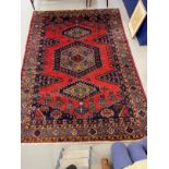 Carpets: Iranian carpet predominantly red and blue ground, small animal motifs. 124ins. x 87ins.
