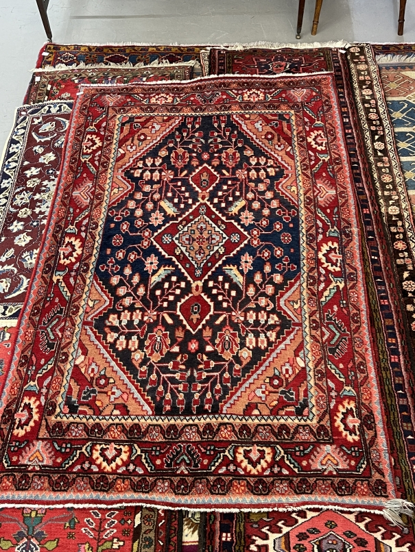 Carpets: 20th cent. Iranian rug predominantly red with central panel of flowers. 82ins. x 50ins.