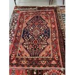 Carpets: 20th cent. Iranian rug predominantly red with central panel of flowers. 82ins. x 50ins.