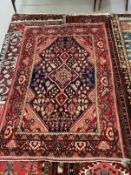 Carpets: 20th cent. Iranian rug predominantly red with central panel of flowers. 82ins. x 50ins.