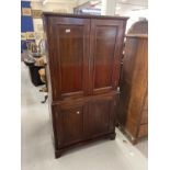 Early 20th cent. Mahogany drinks cabinet two doors above reveal mirrored interior with glass shelves