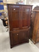 Early 20th cent. Mahogany drinks cabinet two doors above reveal mirrored interior with glass shelves