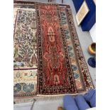 Carpets: 20th cent. Iranian runner with central panel of flowers in soft reddish tones. 123ins. x