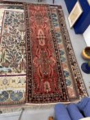 Carpets: 20th cent. Iranian runner with central panel of flowers in soft reddish tones. 123ins. x