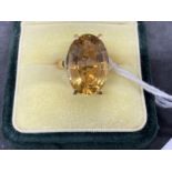 18ct gold ring set with an oval cut golden topaz, estimated weight of 9.00ct. Weight 8.2g.