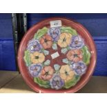 20th cent. Ceramics: Moorcroft plate in the Pansy pattern, on mauve ground. Appears to be a