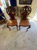 19th cent. Cuban mahogany cabriole leg hall chairs with pierced scroll shaped backs, a pair.