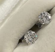 Jewellery: White metal single stone diamond brilliant cut earrings, one at 80pts approx. 5.9mm,