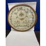 19th cent. Silk sampler depicting birds in trees surrounded by a laurel of rosebuds, forget-me-nots,