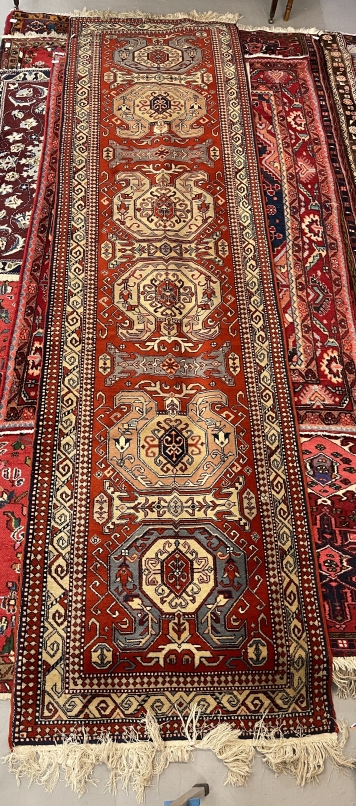 Carpets: 20th cent. Runner with six central geometric panels and three sectioned border. 132ins. x