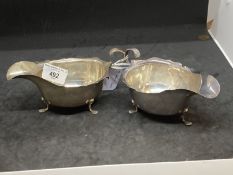 Hallmarked Silver: Pair of sauce boats with scalloped border C scroll handles and three claw feet,