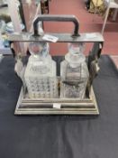 19th cent. Silver plate Betjemans Patent two bottle Tantalus with mismatched decanters plus