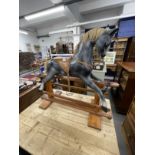 20th cent. Grey rocking horse with glass eyes, horsehair mane and tail on a pitch pine base.