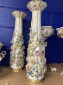 Late 19th/early 20th cent. Porcelain vases, the white bodies covered with encrusted flowers, a pair.