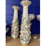 Late 19th/early 20th cent. Porcelain vases, the white bodies covered with encrusted flowers, a pair.