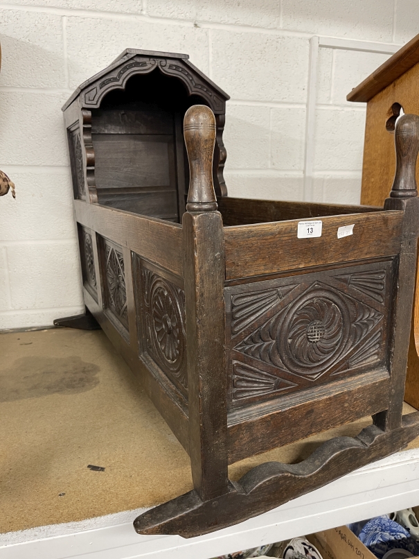 19th cent. Carved oak cradle, shaped hood above carved rockers.