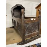 19th cent. Carved oak cradle, shaped hood above carved rockers.