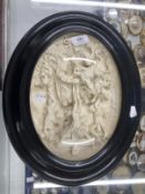 19th cent. Jean Baptiste Revillion: Bas-relief oval plaque, the crucifixion in ebonised frame,