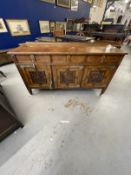 Arts and Crafts style burr walnut sideboard with three drawers over three cupboard doors, the
