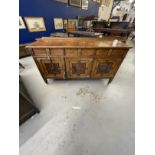 Arts and Crafts style burr walnut sideboard with three drawers over three cupboard doors, the