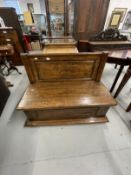 20th cent. Oak low back settle with back panel with carved flower lift up seat above a moulded base.