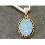 Jewellery: Yellow metal pendant set with an oval opal doublet 14mm x 10½mm set in a rub over