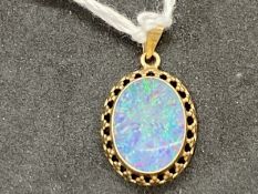Jewellery: Yellow metal pendant set with an oval opal doublet 14mm x 10½mm set in a rub over