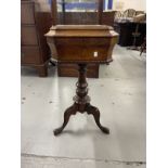 Victorian walnut work table the hinged top with canted corners on a turned column and tripod base.
