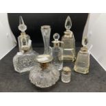Hallmarked Silver: Perfume bottles, glass bottles with silver tops and/or collars, seven in total,