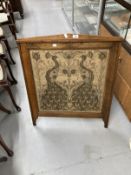 Arts & Crafts: Oak fire screen with inset tapestry panel depicting peacocks.