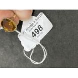 Jewellery: Yellow metal ring claw set with an oval cut citrine, tests as 9ct gold. Ring size P.