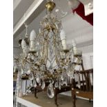 20th cent. Gilt chandeliers, the largest with six shaped branches, glass sconces and drops, 24ins