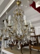 20th cent. Gilt chandeliers, the largest with six shaped branches, glass sconces and drops, 24ins