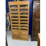 Post-war haberdasher's shop display with sixteen glazed drawers above four others, all with chrome