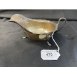 Hallmarked Silver: Cream jug scalloped border C scroll handle on three hoof feet, hallmarked