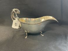 Hallmarked Silver: Sauce boat, gadroon border C scroll handle three trefoil feet, hallmarked