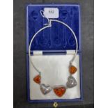 Hallmarked Silver: Torque necklet at the centre are five evenly spaced graduated hearts, three set