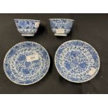 Chinese: K'ang-hsi period (Kang-Xi) tea bowl and saucer, blue and white floral pattern (