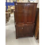 Early 20th cent. Mahogany drinks cabinet two doors above reveal mirrored interior with glass shelves