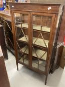 Edwardian two door display cabinet on square tapered legs inlaid with satinwood. 30ins. x 13½ins.