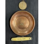 Militaria/Royal Navy: H.M.S. Hood copper ashtray, penknife, Hood Whalers Club medal. (3)