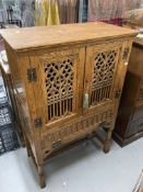 20th cent. Gothic style oak larder cupboard with two pierced and carved doors above a single fall,