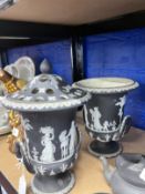 19th cent. Wedgwood black Jasper two handled urns, one with cover, the other minus cover and A/F.